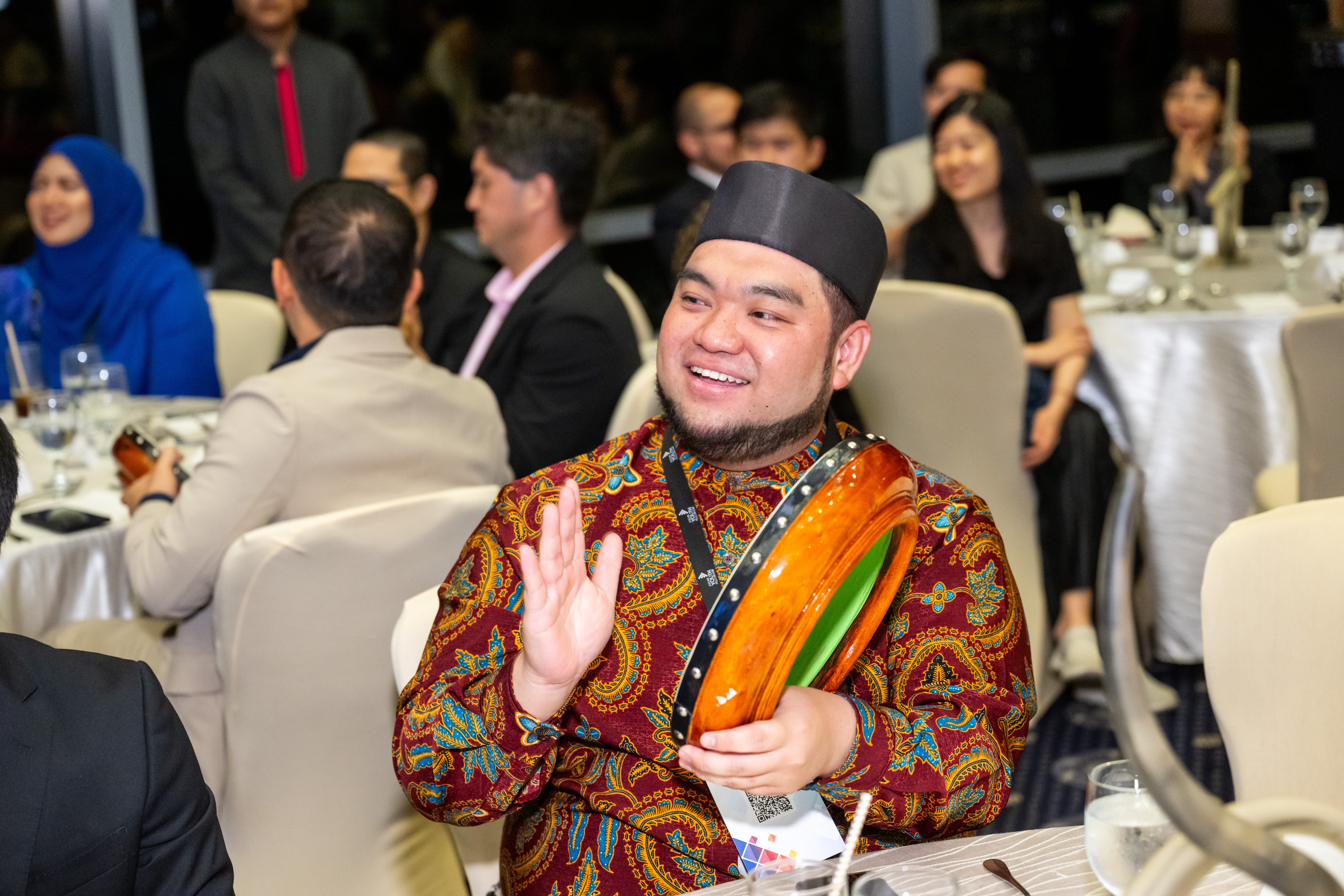 A Bruneian Fellow playing the kompang as part of the welcome dinner's opening performance